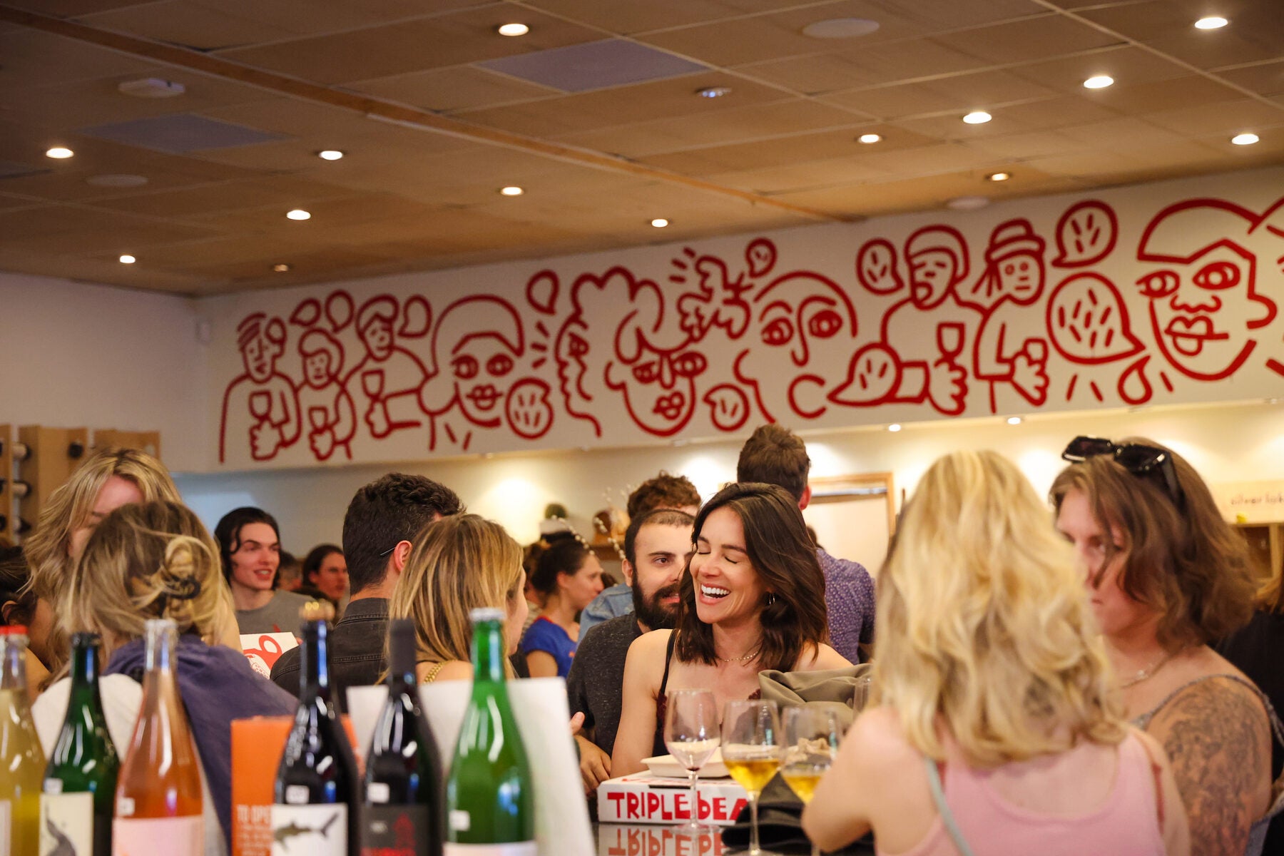 A laugh in front of the mural