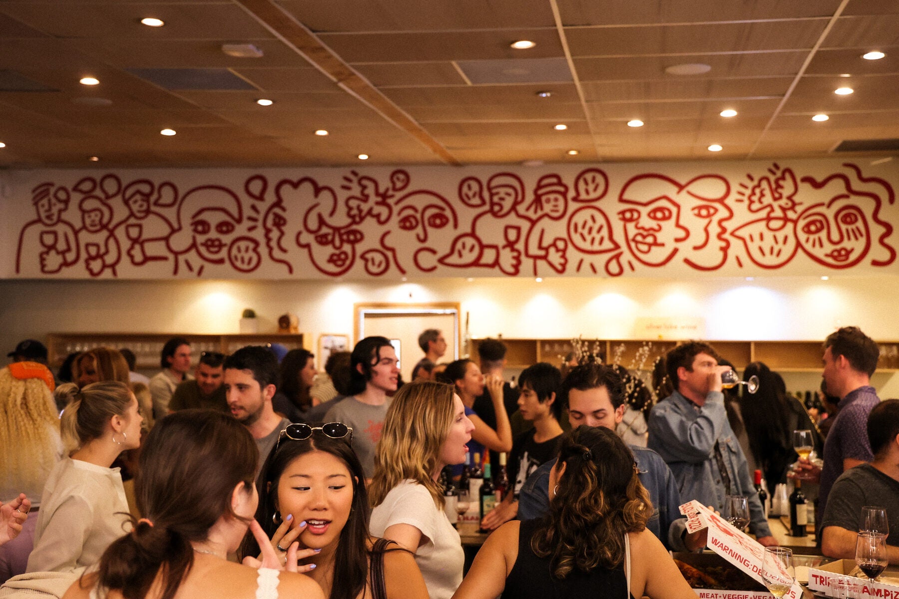 The Silver Lake Wine mural over the bar with people