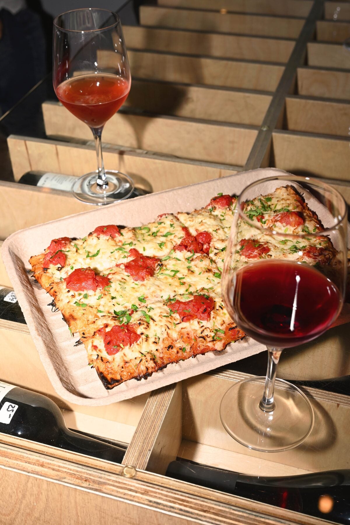 Detroit-style pizza with two wine glasses